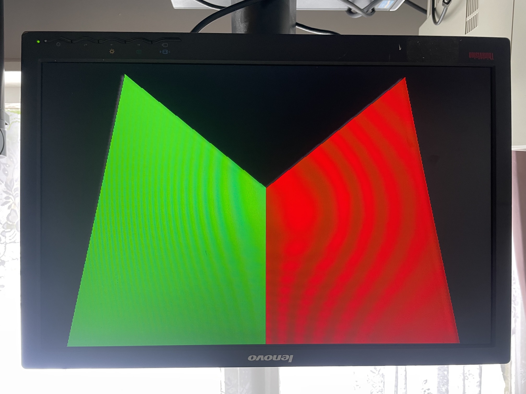 Two overlapping triangles resolved by depth, red and green, on a monitor